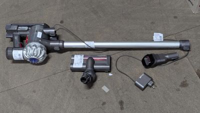 a corded vacuum that is laying on the ground