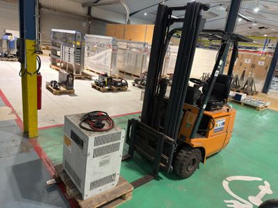 a fork lift truck parked in a warehouse with boxes on the floor