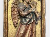an antique brass plaque with an angel holding a trumpet