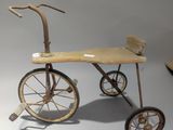 a small wooden tricycle that is sitting on a table