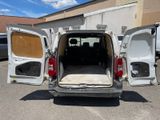 a white van with its doors open in a parking lot