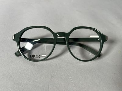 a pair of glasses sitting on a white surface