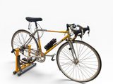 a bike that is sitting on a stand on a white background