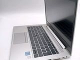 a laptop computer sitting on a white surface
