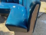 a blue couch that is sitting on the side of the street