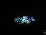 an image of a close up of a ring with blue crystals on it