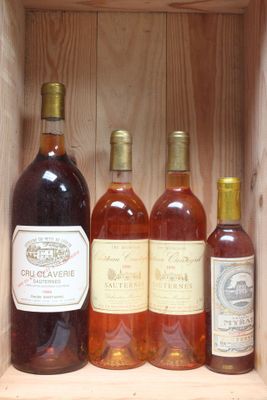 several bottles of wine sit in a wooden box on a shelf
