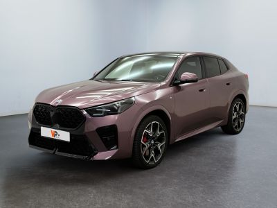 a pink car parked in a room with a white wall