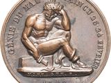 an image of a bronze medal with a man sitting on a bench