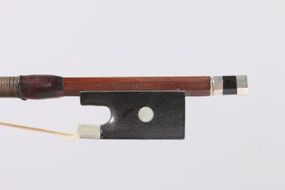 a violin bow with a wooden handle and a metal tip