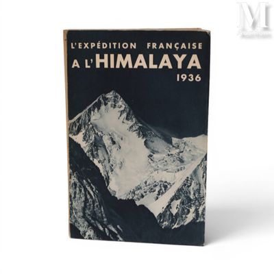 an old book with a picture of a mountain in the background