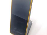 a cell phone that is sitting on top of a stand