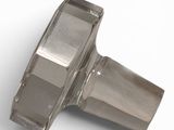 a close up of a metal object on a white surface