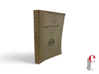 an old book sitting on top of a table next to a red and white logo