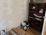 boxes are stacked on the floor in the corner of a room