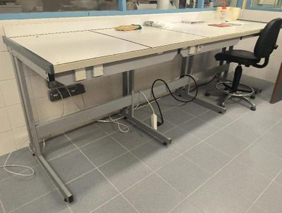 a desk with two chairs and a computer on it