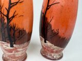 two vases that have been painted with trees on them