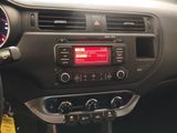 the dashboard of a car with a clock and radio in it