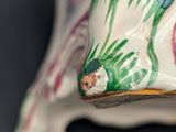 a close up of a vase with a bird on it