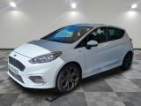 the white ford fiesta is parked on a checkered floor