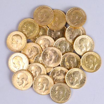 a pile of gold coins sitting on a white surface