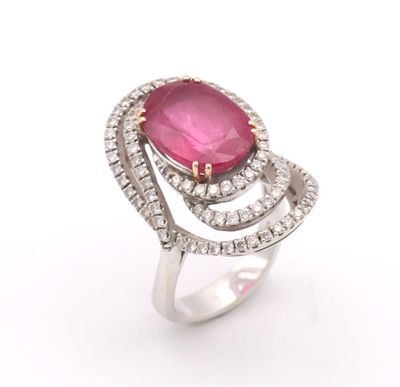a close up of a pink stone and diamond ring on a white background