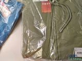 two bags of clothing sitting on a table next to each other