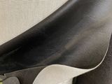 a close up of a person wearing a pair of black shoes