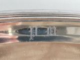 a close up of a silver plate with writing on it