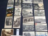 an old photo of a bunch of old postcards sitting on top of a table
