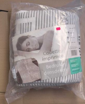 a pillow that is wrapped in plastic on the floor