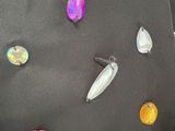many different colored stones on the black fabric