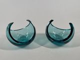 pair of blue glass vases on a white surface