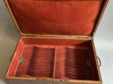 a wooden box that has a bunch of glasses inside of it