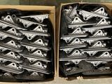 two boxes filled with metal parts sitting on top of a wooden floor