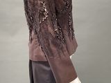 an image of a mannequin wearing a brown jacket and skirt