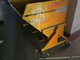 a yellow box sitting on top of a dolly in a hallway