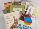 several books are sitting on a table with a white table cloth