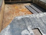 a large piece of metal on the ground in the back of a truck