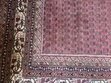 an image of a rug on a wooden floor with a cat laying on top of it