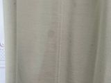 the back of a white shirt hanging on a hanger