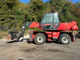 a red tractor that is parked in the dirt