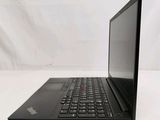 the back of a laptop computer sitting on top of a white table