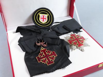 a red box with a cross and other items in it