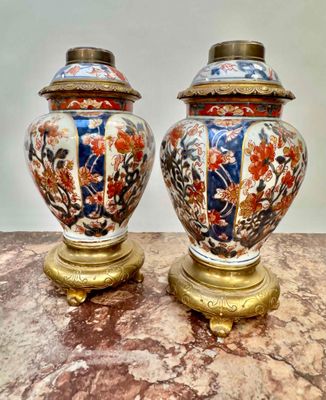 two vases that are sitting on a marble table