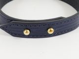 a close up of a black leather dog collar with gold studs