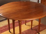 a wooden table with two legs and a wooden table top