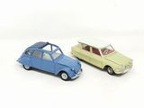 two toy cars sitting next to each other on a white surface