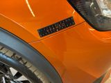 a close up of a car ' s headlight with a sticker on it