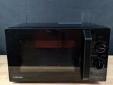 black toaster oven sitting on top of a wooden table
